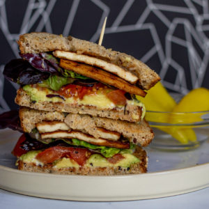 Vegan BLTA sandwich with Tofu Bacon, Tomato, Lettuce, and Avocado