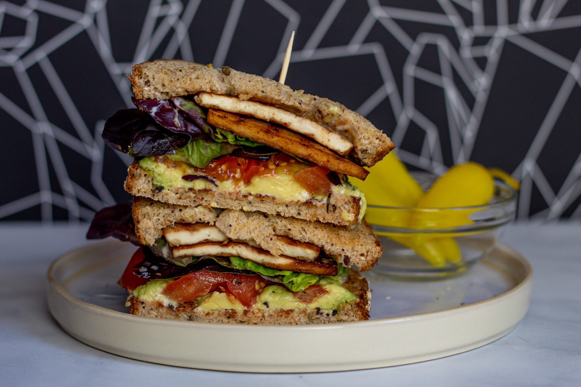 Vegan BLTA sandwich with Tofu Bacon, Tomato, Lettuce, and Avocado