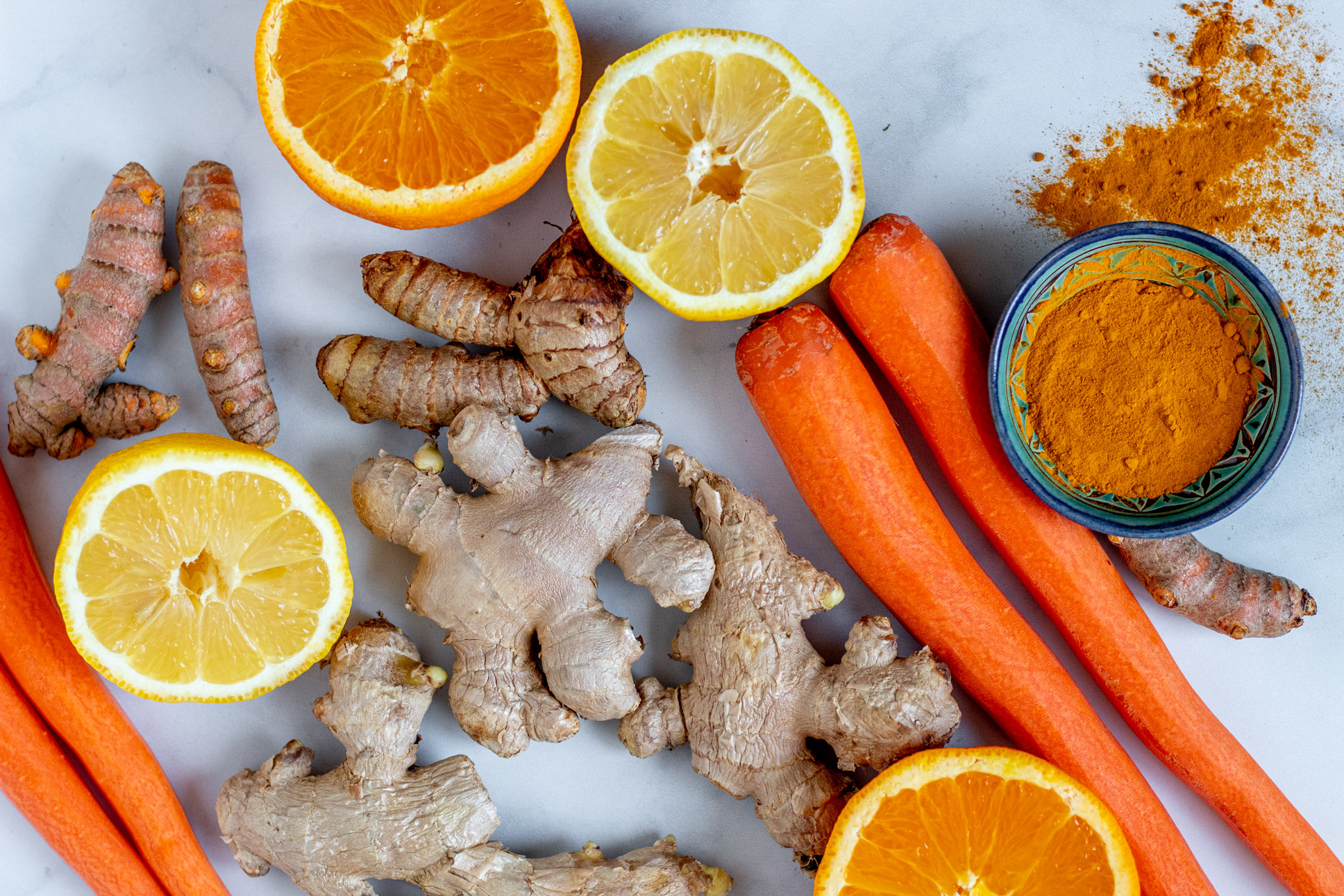 Oranges, lemon, ginger, turmeric, and carrot juice