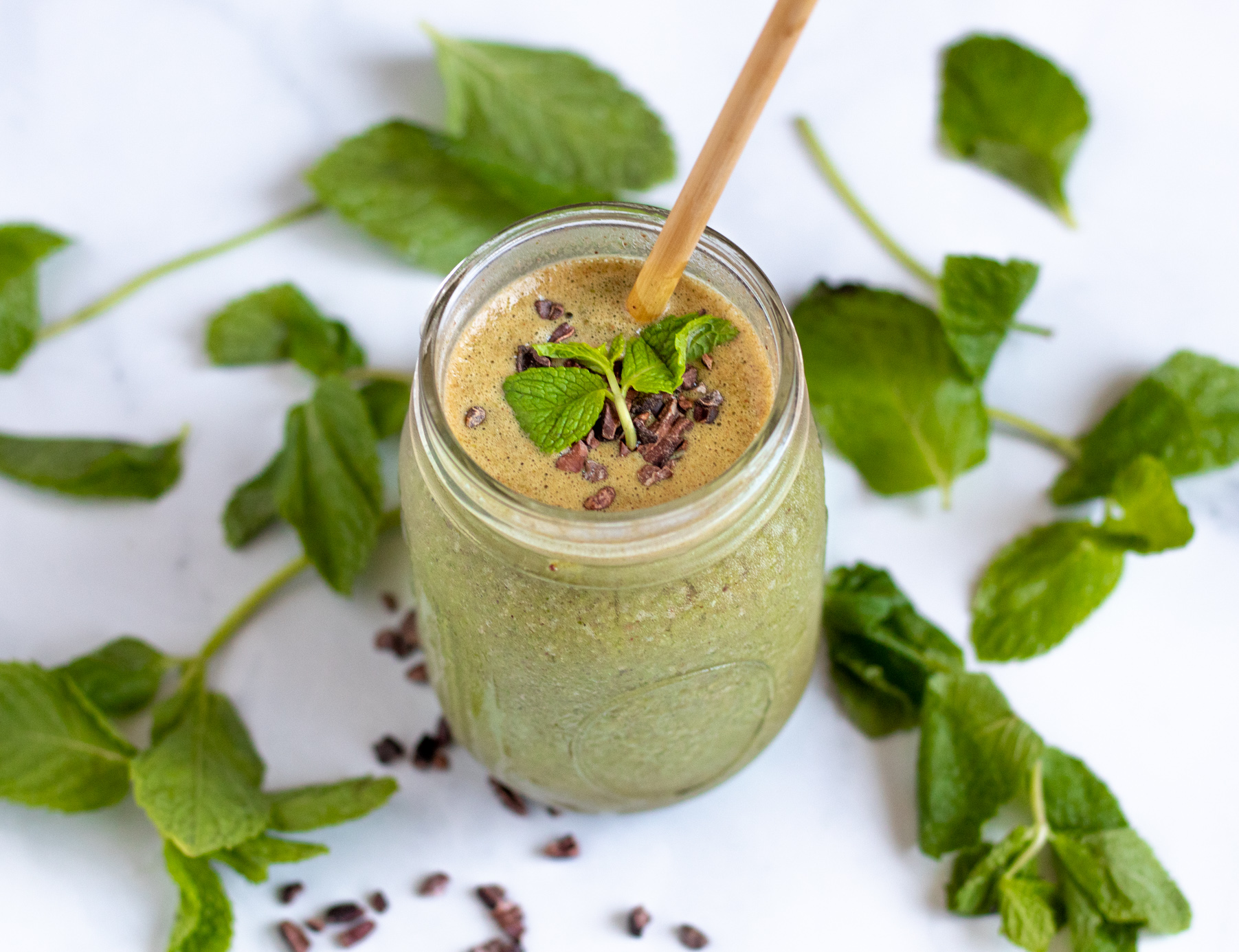 Mint Chocolate Chip Smoothie with mint leaves and cacao nibs