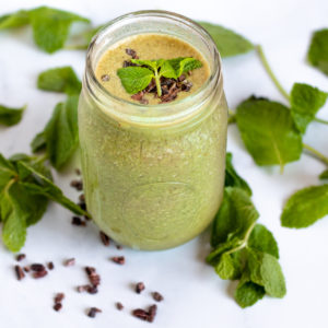 Healthy mint chocolate chip smoothie with mint leaves and cacao