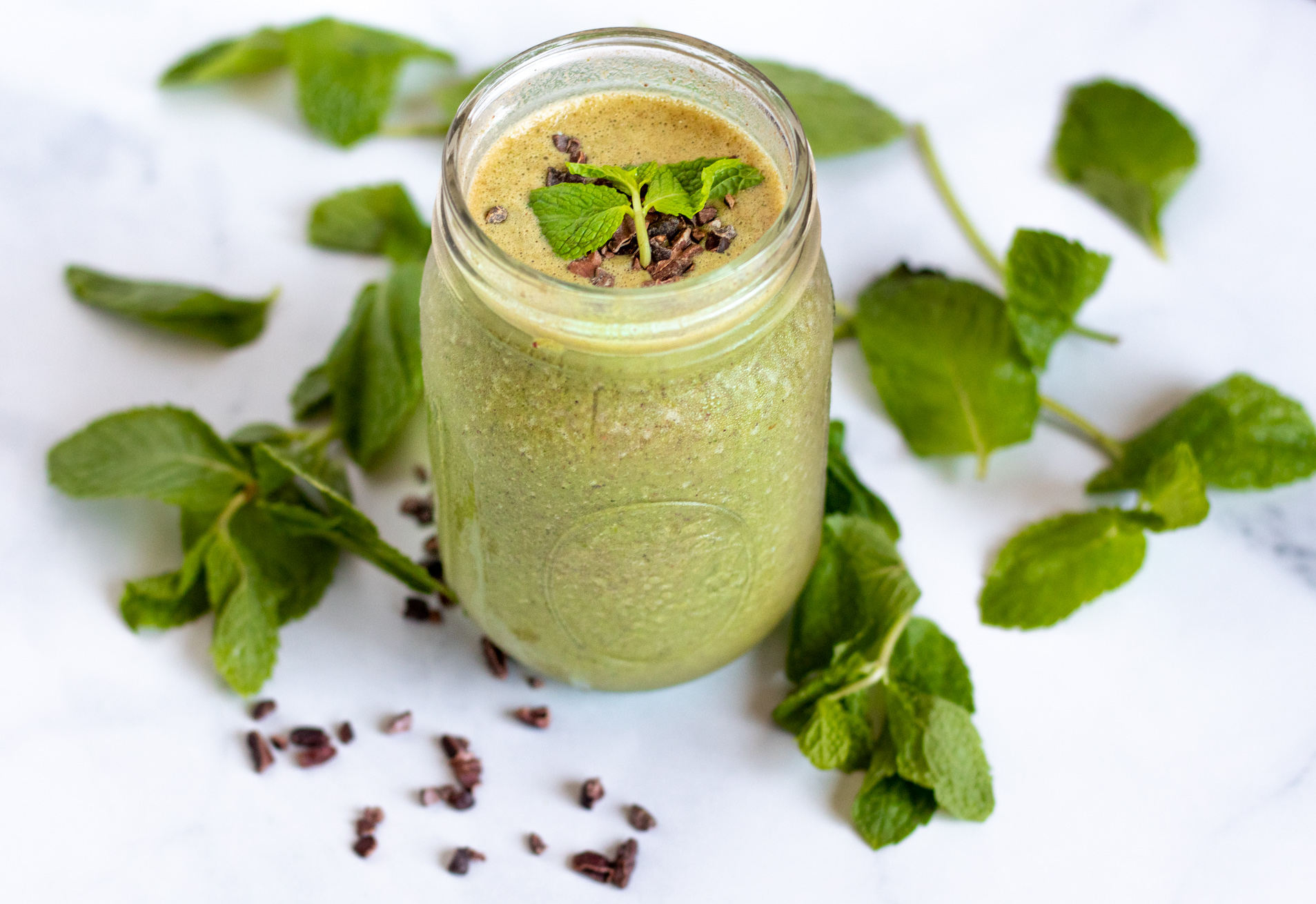 Healthy mint chocolate chip smoothie with mint leaves and cacao