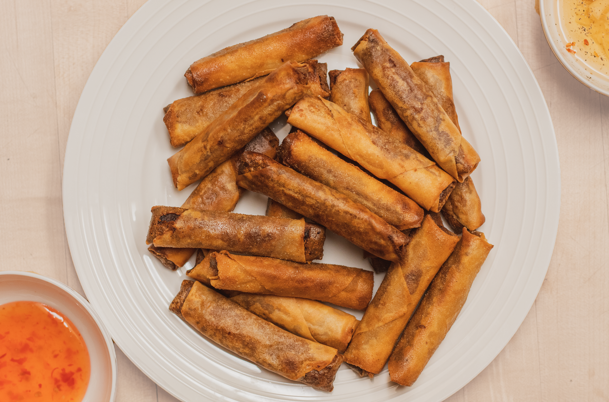 plate of vegan lumpia with sweet chili and vinegar