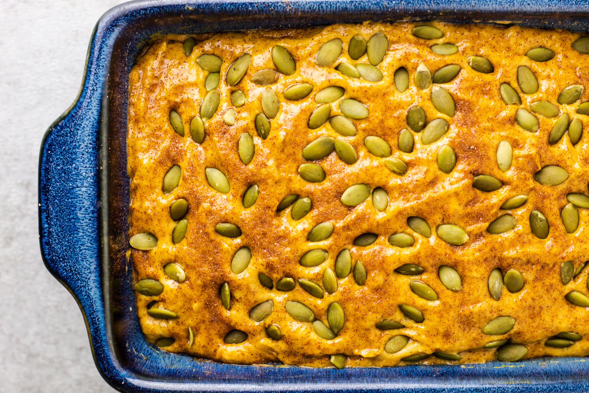 Pumpkin Spice Banana Bread batter with pumpkin seeds