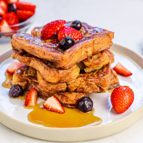 Vegan cinnamon french toast just egg, strawberries, blueberries, fruit, maple syrup, plantbased butter