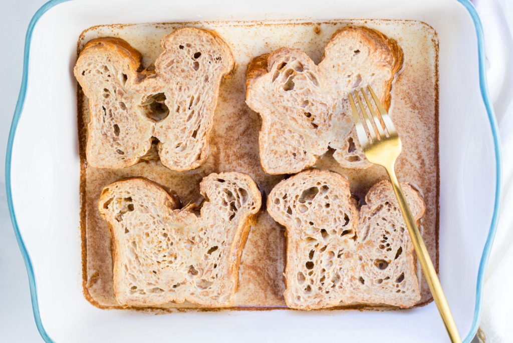 Vegan Cinnamon French Toast Just Egg baking dish with fork soaking