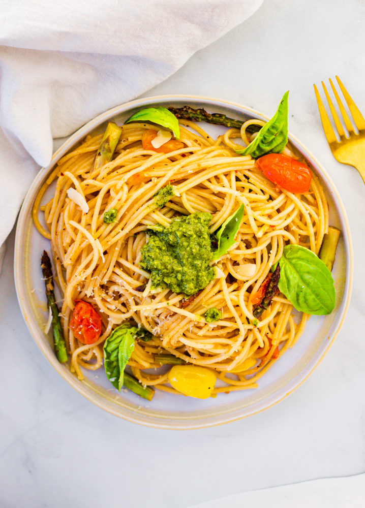 Springtime Pasta Vegan with plantbased butter, garlic, asparagus, cherry tomatoes, basil, and lemon