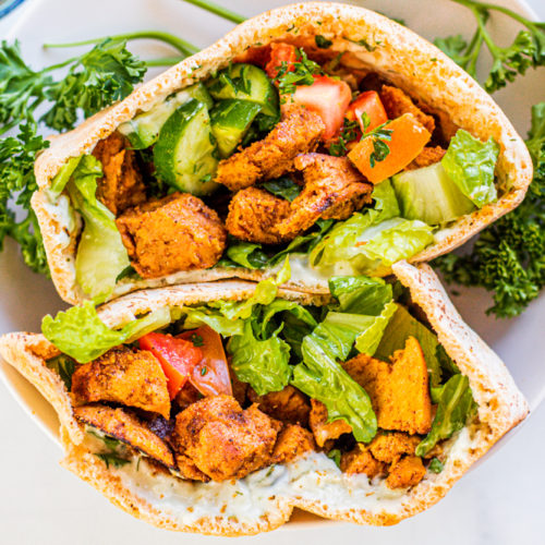 Vegan Chicken Shawarma with spices, pita pocket, flatbread, parsley, cucumber, garlic sauce, hummus