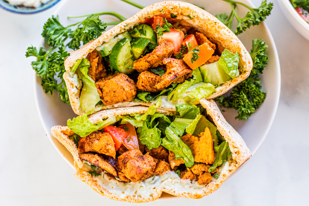 Vegan Chicken Shawarma with spices, pita pocket, flatbread, parsley, cucumber, garlic sauce, hummus