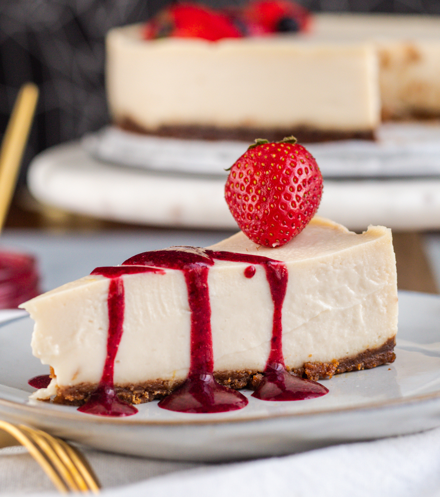 New York Vegan Cheesecake - slice with berry sauce plantbased strawberries